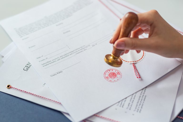 Notary,Public,Authorizing,Document,With,Hers,Notary,Stamper